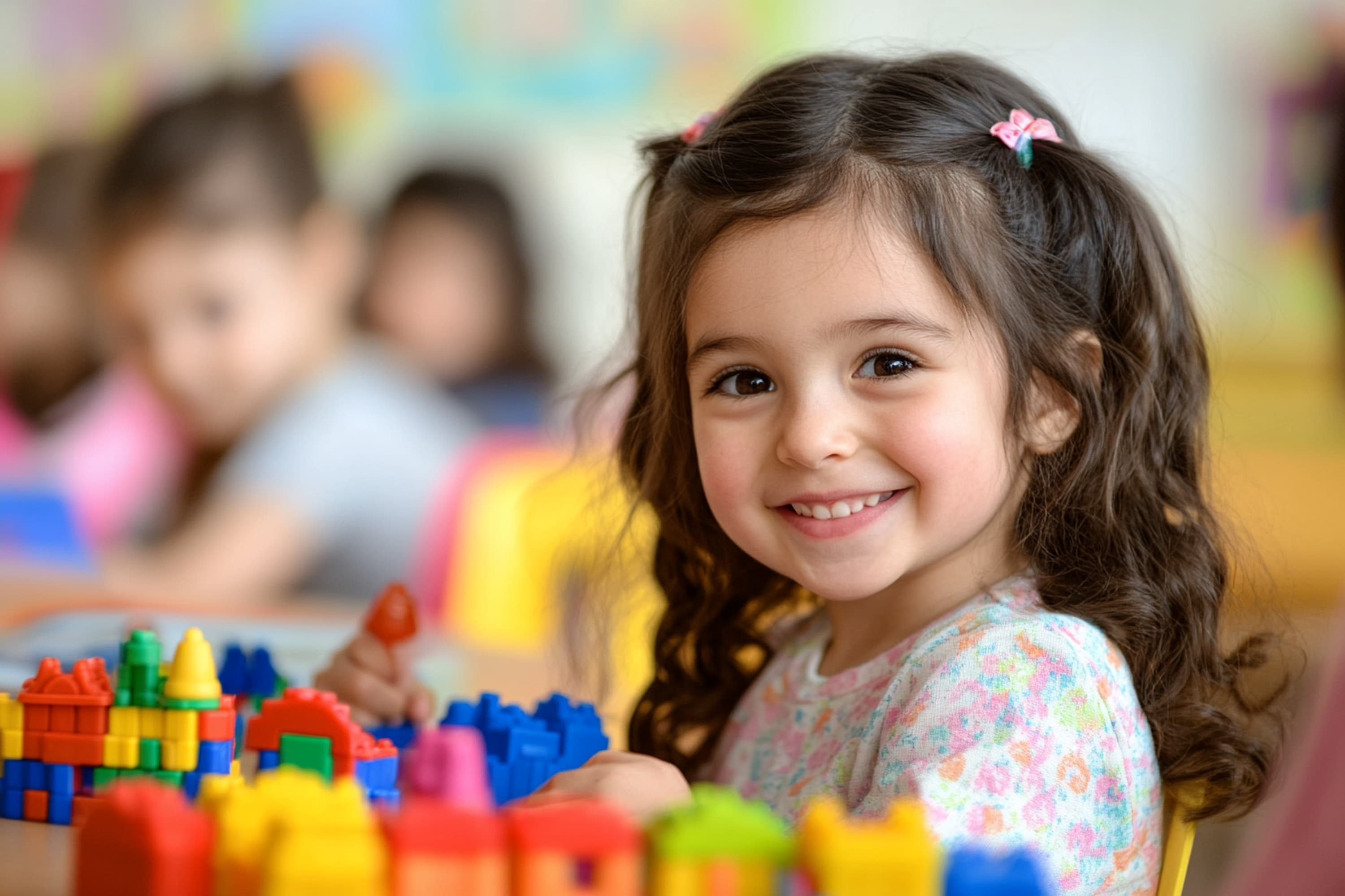 Young girl smiling while playing with toys.